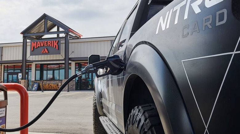 A pickup truck refueling at a Maverik gas station.