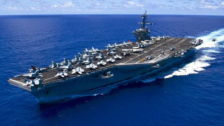USS Carl Vinson out at sea, with a deck full of aircraft