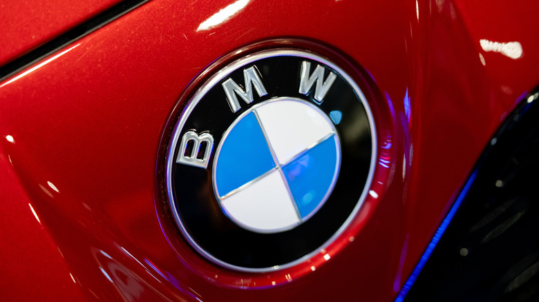 Close-up of a BMW logo on a red vehicle