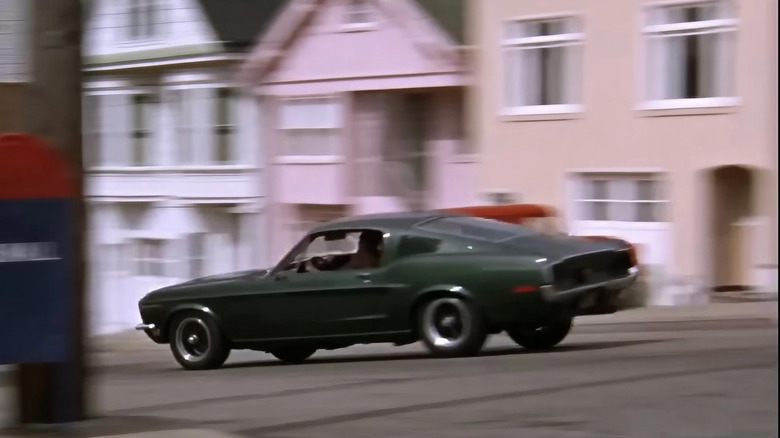 McQueen's Ford Mustang Fastback flies by residential street in "Bullitt"