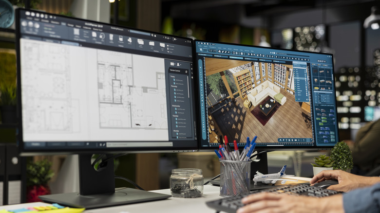 Dual-monitor desk setup with CAD programs on screen.