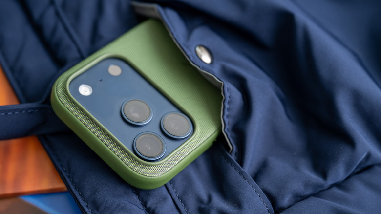 iPhone 17 Pro in Green TechWoven Case sticking out of a bag pocket