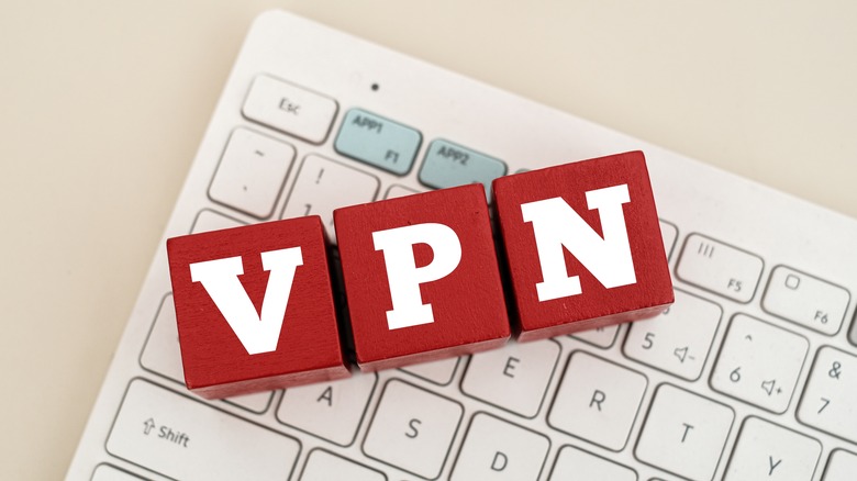 Three red blocks that spell out VPN on a white USB QWERTY keyboard.