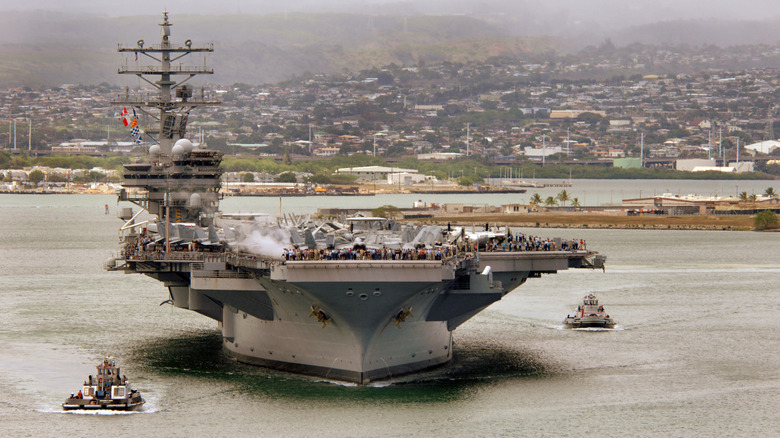 Nimitz-class aircraft carrier USS Ronald Reagan (CVN 76) prepares to depart Hawaii after a four-day port visit.