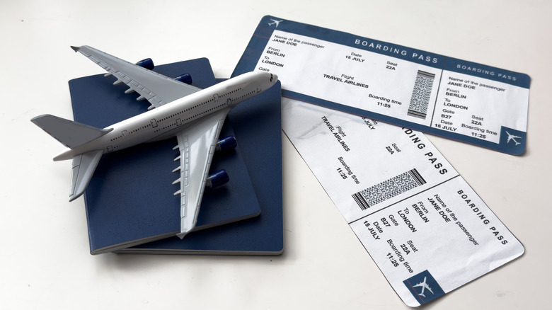Picture displaying a model plane and boarding passes