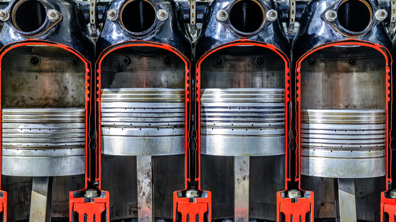 Cutaway view of four cylinder piston engine showing inside of combustion chamber and cylinders