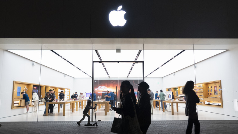 People purchasing and exploring products at Apple store