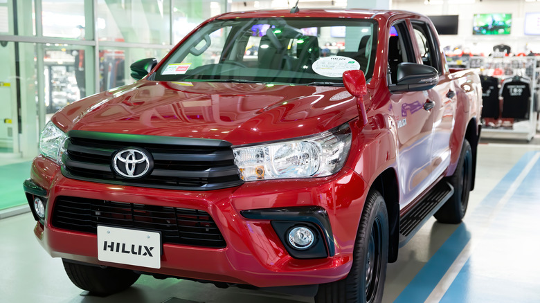 a red toyota hilux in showroom