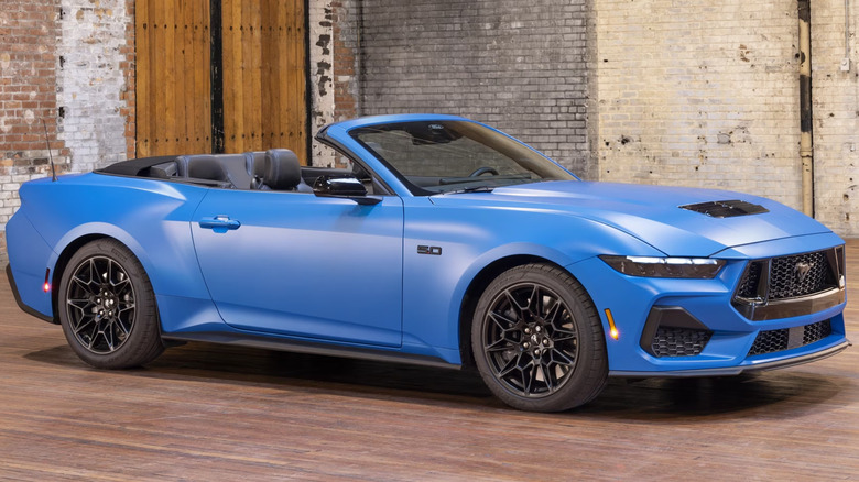 Front 3/4 view of a blue Ford Mustang Convertible with the side marker lights on