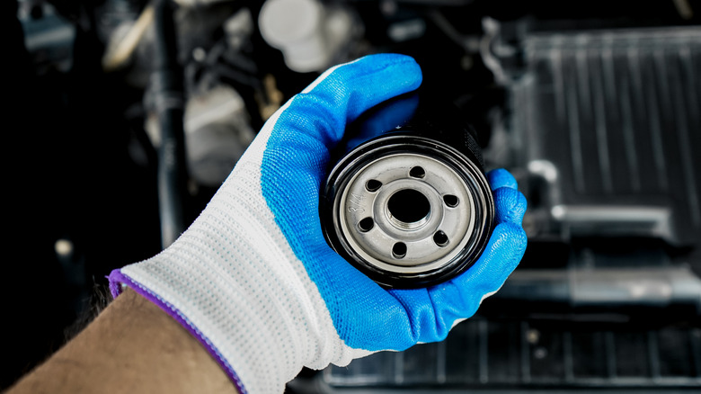 Close-up of mechanic holding a spin-on type oil filter