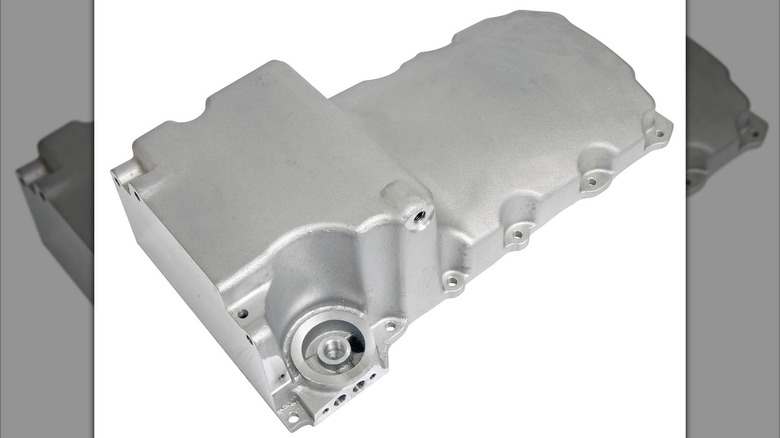 A cast aluminum oil pan on a white background