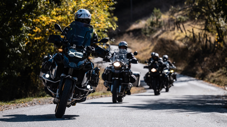 Group of motorcyclists riding their adventure motorcycles on a narrow road