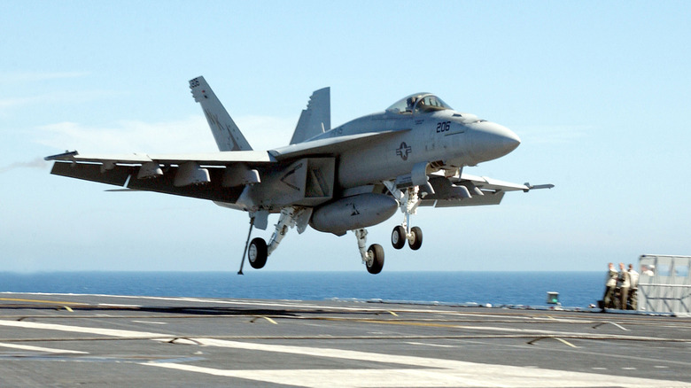 An F/A-18 Hornet makes a landing on the USS Abraham Lincoln aircraft carrier
