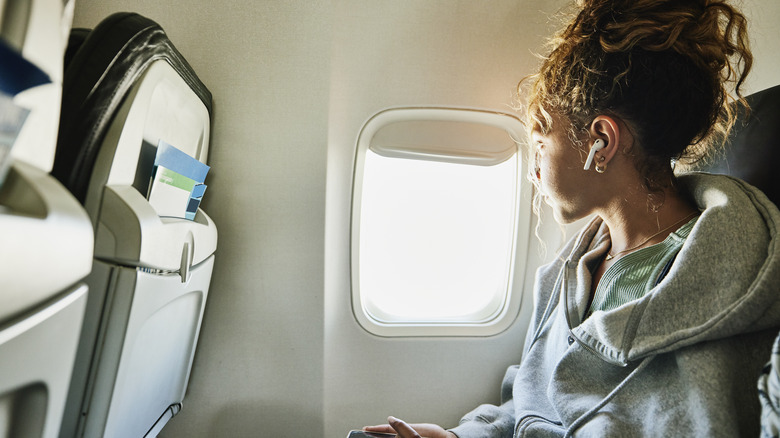 airplane passenger looking out side window