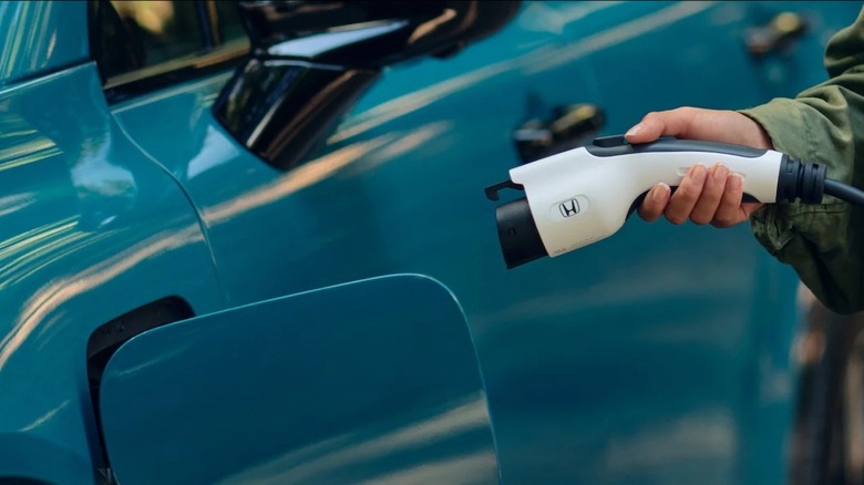 2025 Honda Prologue EV with person about to plug in a charger
