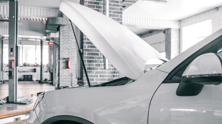White car with an open hood or bonnet