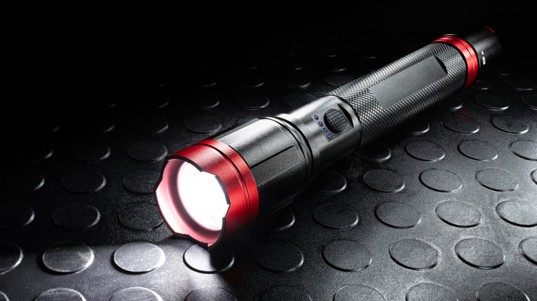 A black and red metal LED flashlight