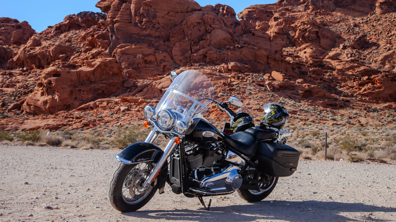 Harley Davidson parked by red rocks in Valley of Fire State Park in Nevada