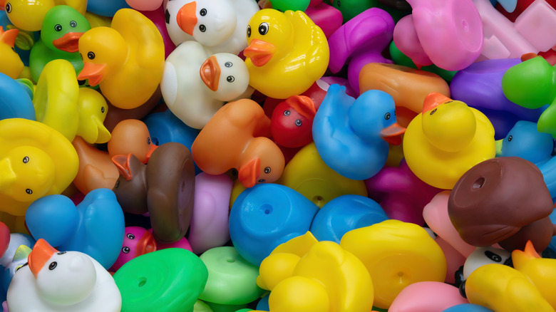 Large pile of different colored rubber ducks
