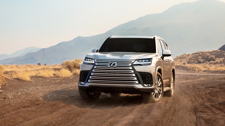 2023 Lexus LX, front-view showcasing Ultra-Luxury package grille, parked on dirt trail