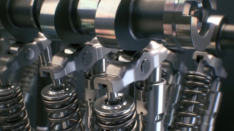 An illustration of the rolling finger followers that reduce camshaft lobe friction