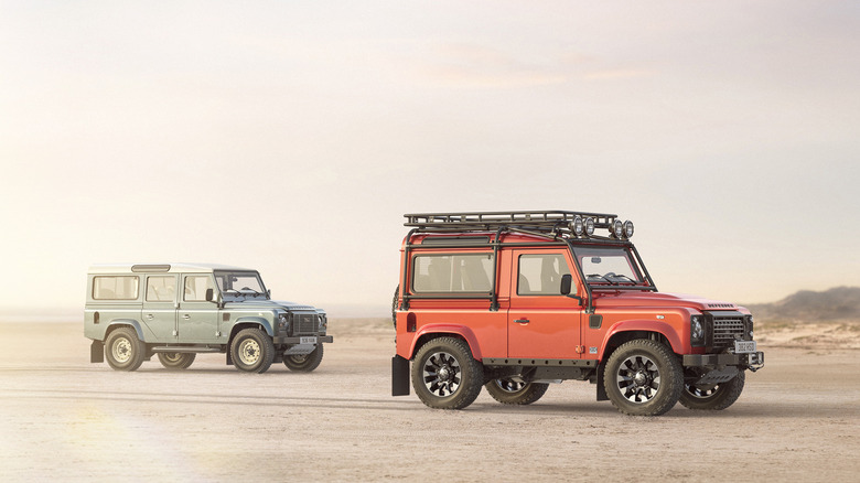 Side shot of a 90 and 110 Land Rover Classic Defender V8 Works parked on the beach