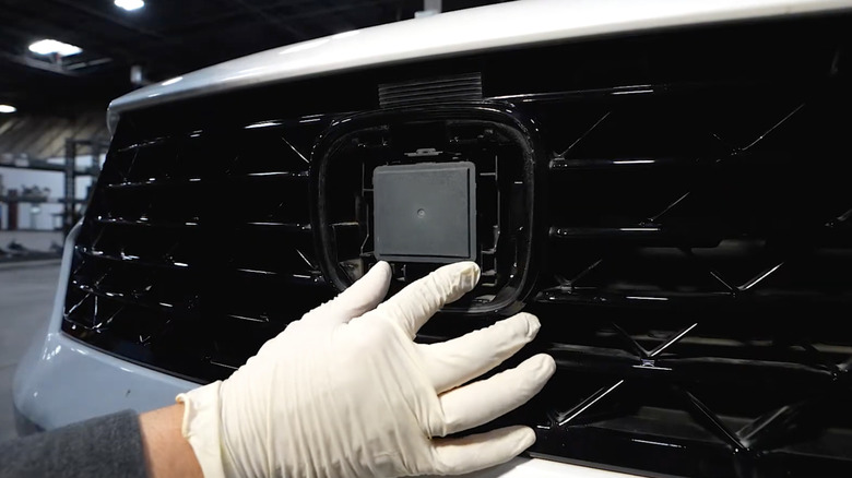 A Honda radar sensor fitted into the empty casing on a vehicle grille