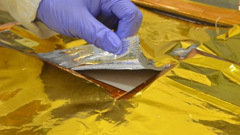 Engineers from the National University of La Plata working on a Multi-layer insulation method for the SAOCOM Satellite.