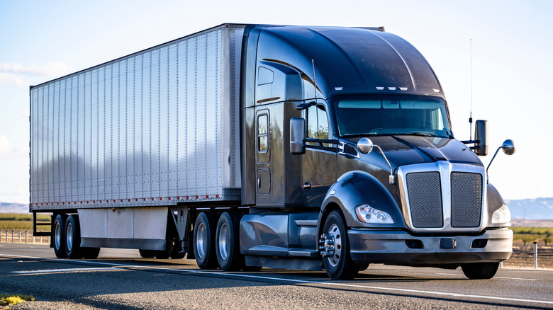 Industrial long hauler big rig black semi truck tractor