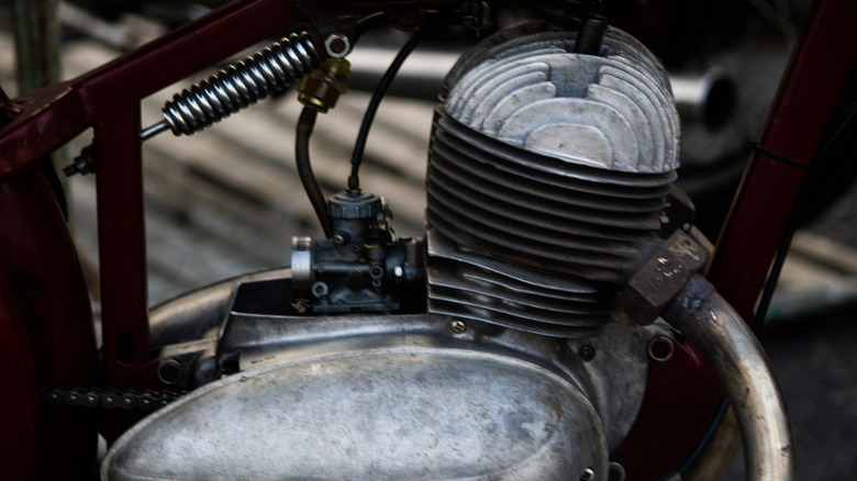 Side view of a vintage, single-cylinder motorcycle engine