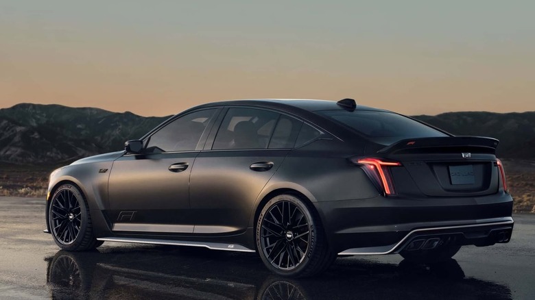 Rear-left view of a black 2026 Cadillac CT5-V Blackwing in the evening