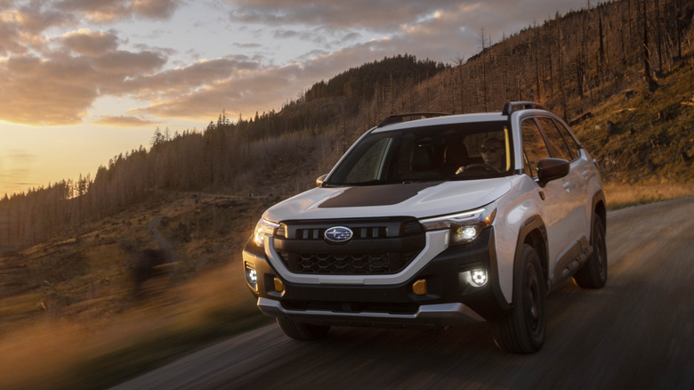 2026 Subaru Forester driving in forest terrain, front-left 3/4 view