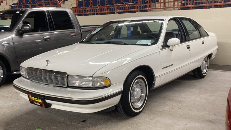 White 1996 Chevrolet Caprice Classic in a parking garage.