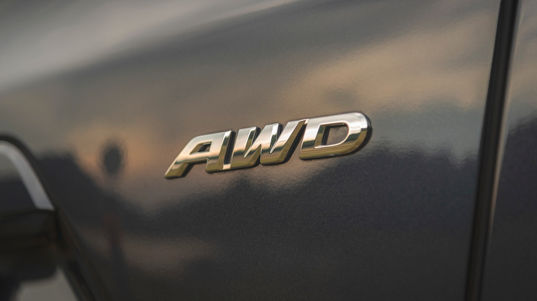 A badge reading AWD on the back of a grey crossover