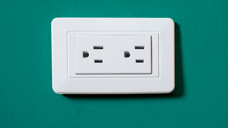 sideways electrical outlet in a green wall