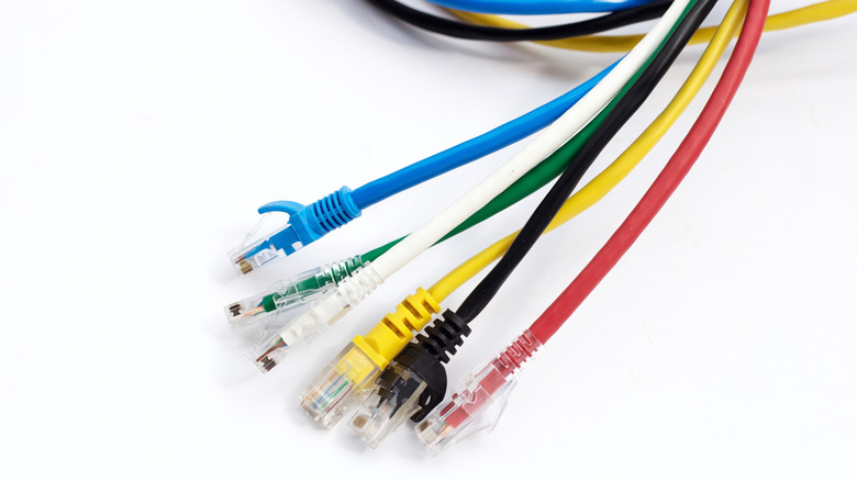 Different colored Ethernet cables on white background