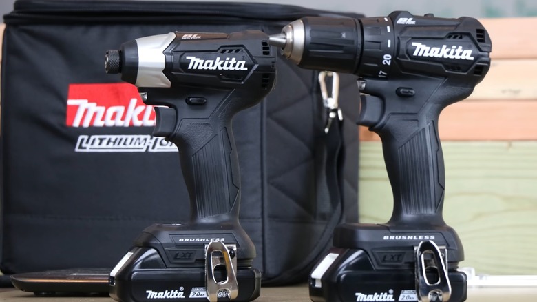 A set of black Makita drills on a table.