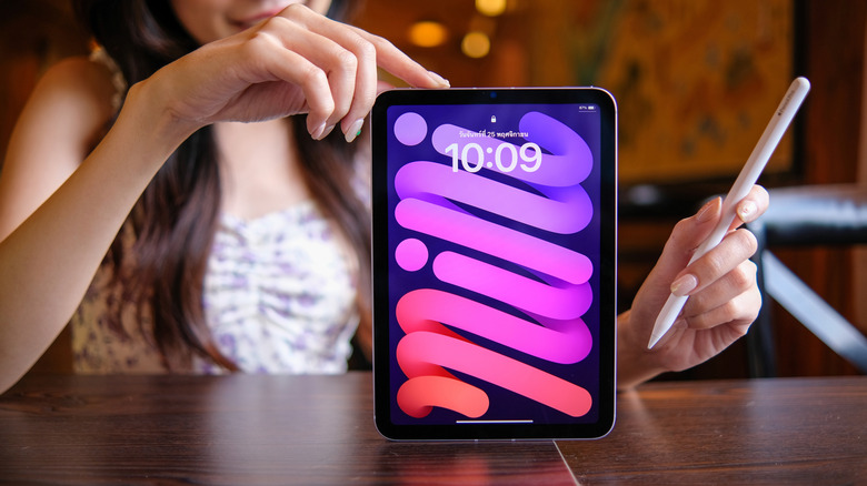 Woman displaying an iPad mini