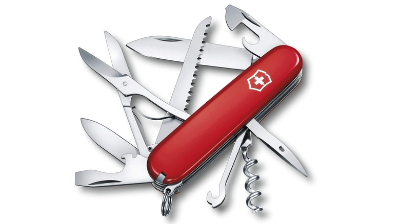 New Swiss Army Knife with blades partially open on plain background