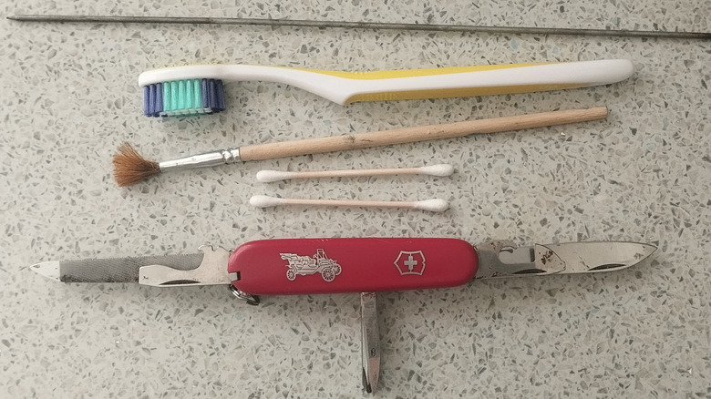 Dirty Swiss Army Knife with cleaning tools