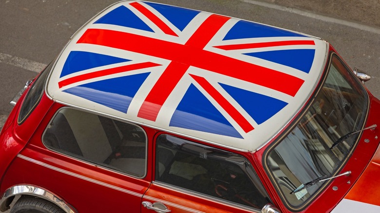 Red car with the British flag (Union Jack) on its roof