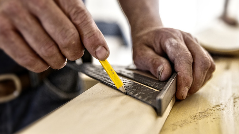 Person using flat woodworking pencil