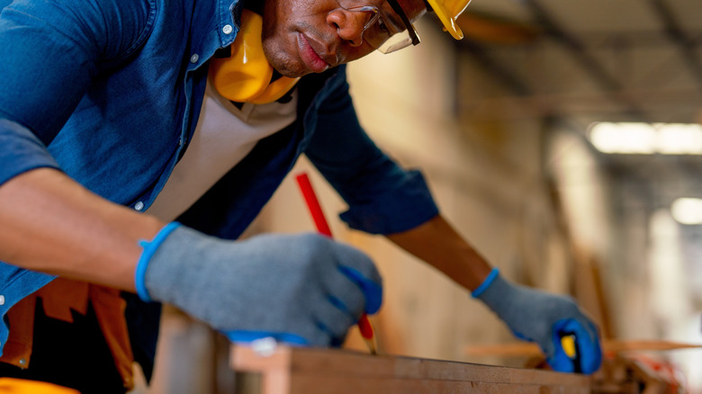 Person using flat woodworking pencil