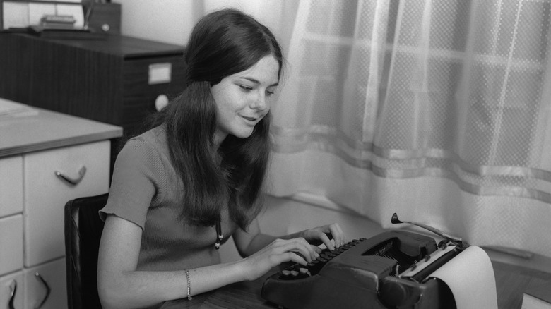 vintage image of young woman using a typewriter
