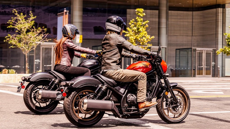 Two riders onHonda Rebel 1100 DCT motorcycles in city