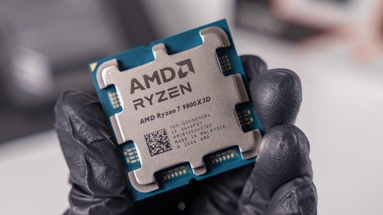 PC builder holding a Ryzen 7 9800X3D CPU