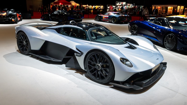 A silver Aston Martin Valkyrie hybrid sports car on display, surrounded by other sport cars Geneva, Switzerland - Feb 26, 2024.