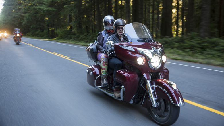 Excited couple enjoying a bike ride on the highway