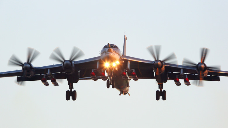 Tupolev Tu-95 "Bear" on final approach with landing lights on, gear and flaps deployed, front view