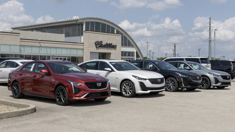 Cadillac CT5 and CT4 sedans parked side by side at dealership
